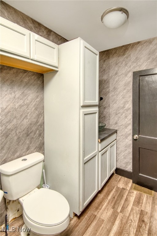 bathroom featuring toilet and hardwood / wood-style flooring