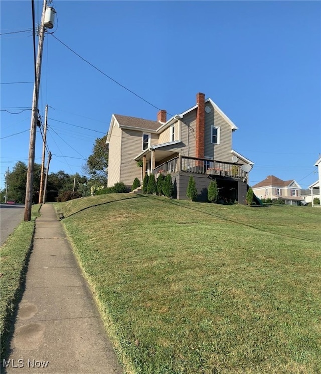 view of property exterior featuring a yard and a deck