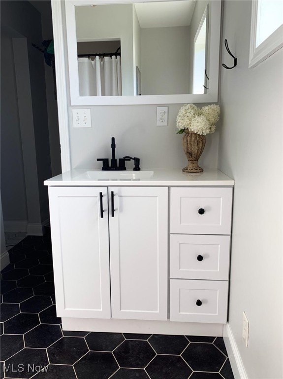 bathroom with tile patterned floors and vanity