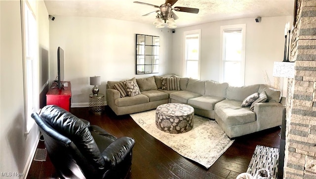 living room with ceiling fan and dark wood-type flooring