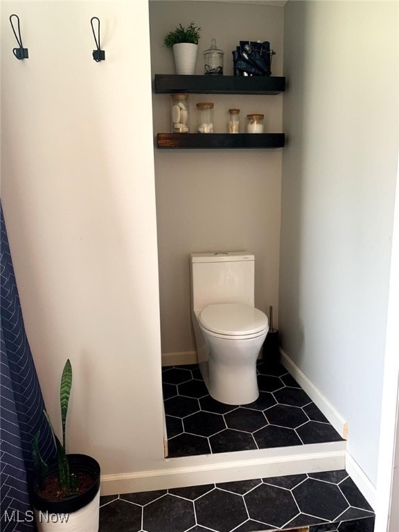 bathroom featuring tile patterned flooring and toilet