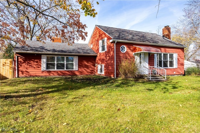 rear view of property featuring a yard