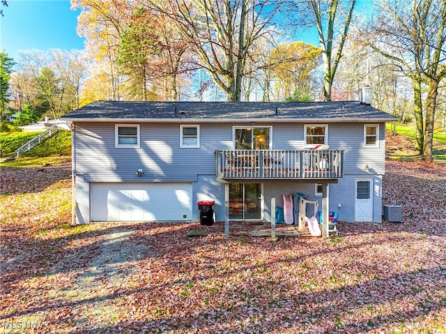 rear view of house featuring central AC, a garage, and a deck