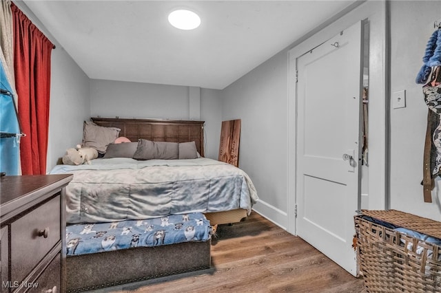 bedroom with hardwood / wood-style floors