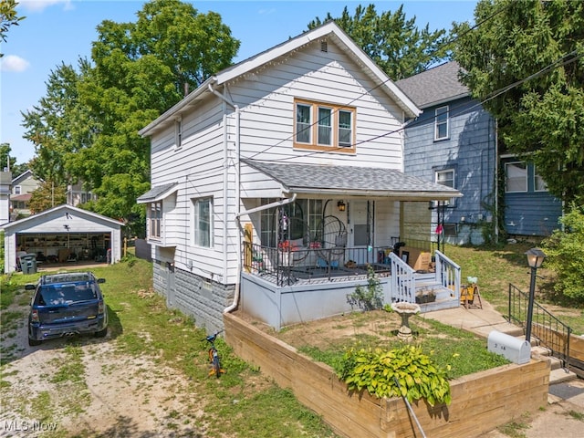 bungalow-style house with an outbuilding, a garage, and covered porch