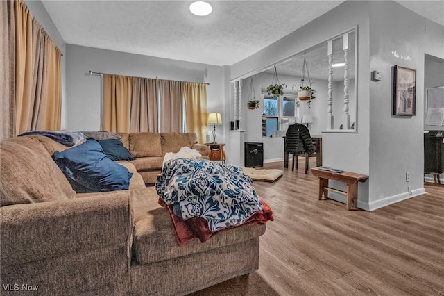 living room with hardwood / wood-style flooring and a textured ceiling