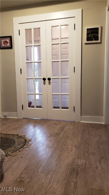 doorway to outside with dark hardwood / wood-style flooring and french doors