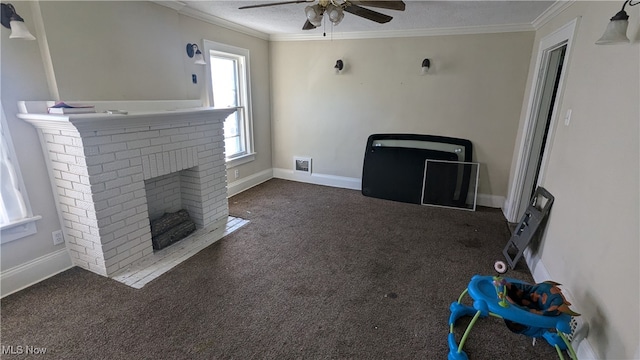 unfurnished living room with dark colored carpet, crown molding, ceiling fan, a fireplace, and a textured ceiling