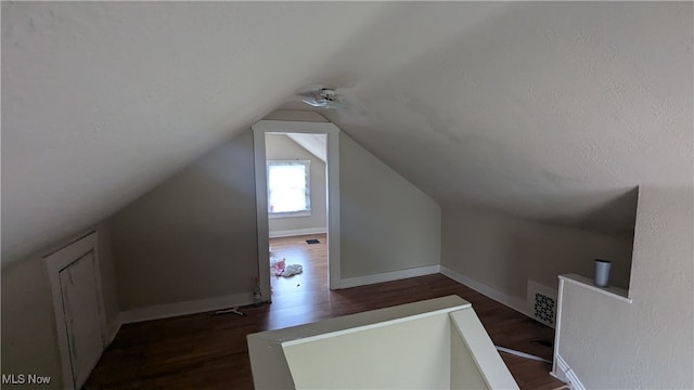 bonus room with dark hardwood / wood-style flooring and lofted ceiling