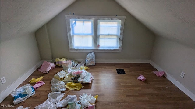 bonus room featuring hardwood / wood-style flooring and vaulted ceiling