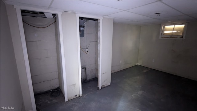 basement featuring a paneled ceiling