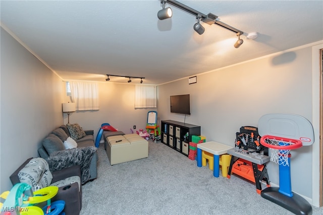 game room with carpet, crown molding, and track lighting