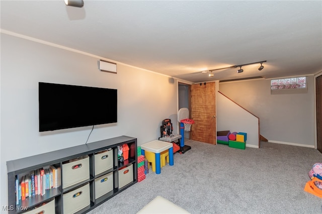 recreation room with carpet flooring and track lighting