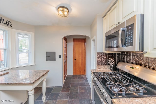 kitchen with light stone countertops and stainless steel appliances