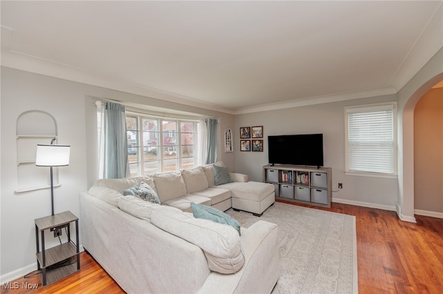 living room with hardwood / wood-style floors and crown molding