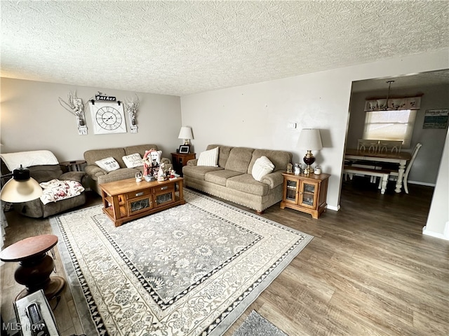 living room with wood-type flooring and a textured ceiling