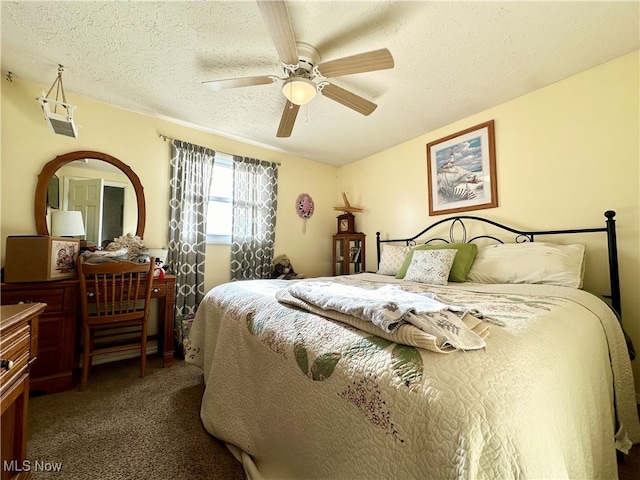 carpeted bedroom with ceiling fan and a textured ceiling