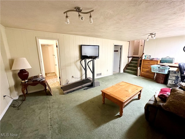 living room featuring a textured ceiling and carpet floors