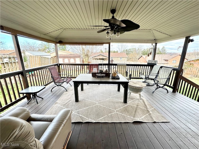 wooden terrace with a gazebo, an outdoor living space, and ceiling fan