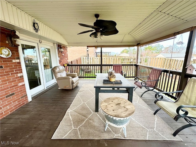 exterior space featuring ceiling fan and vaulted ceiling