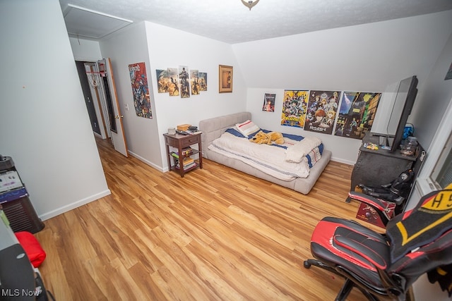 bedroom featuring a textured ceiling and light hardwood / wood-style floors