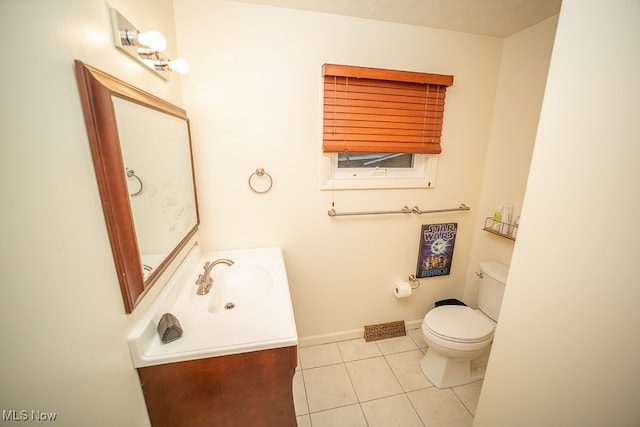 bathroom with tile patterned floors, vanity, a textured ceiling, and toilet