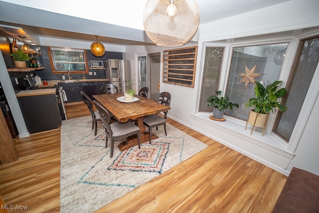 dining room featuring hardwood / wood-style floors and sink