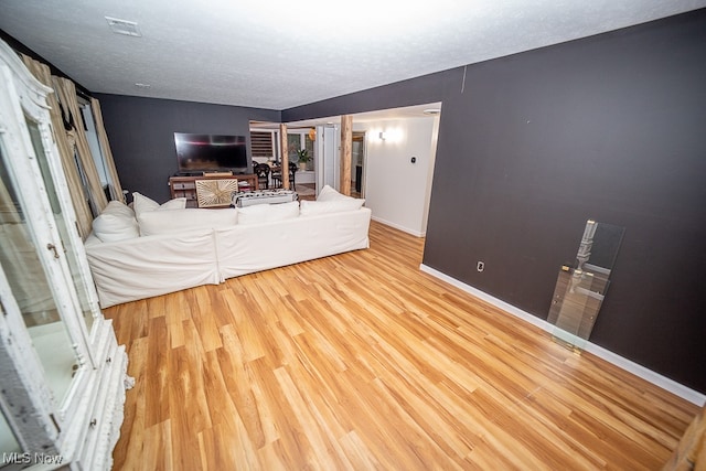 bedroom with a textured ceiling and hardwood / wood-style flooring