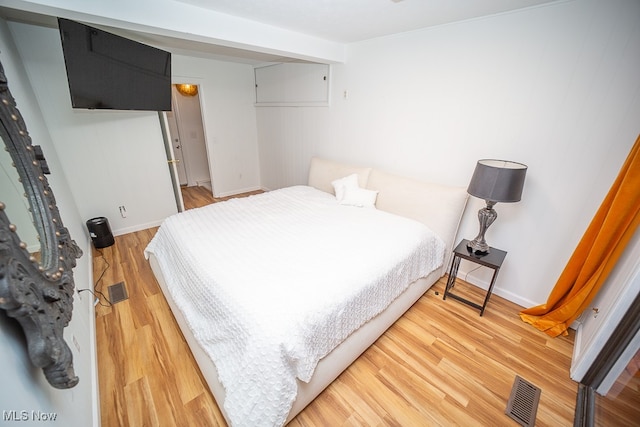 bedroom with wood-type flooring