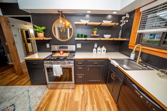 kitchen with dishwasher, sink, hanging light fixtures, stainless steel gas stove, and light wood-type flooring