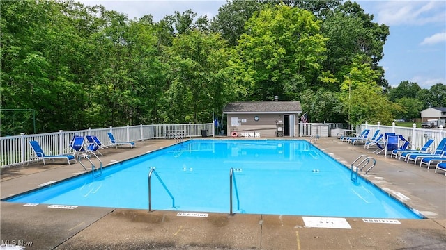 view of pool featuring a patio area and an outdoor structure