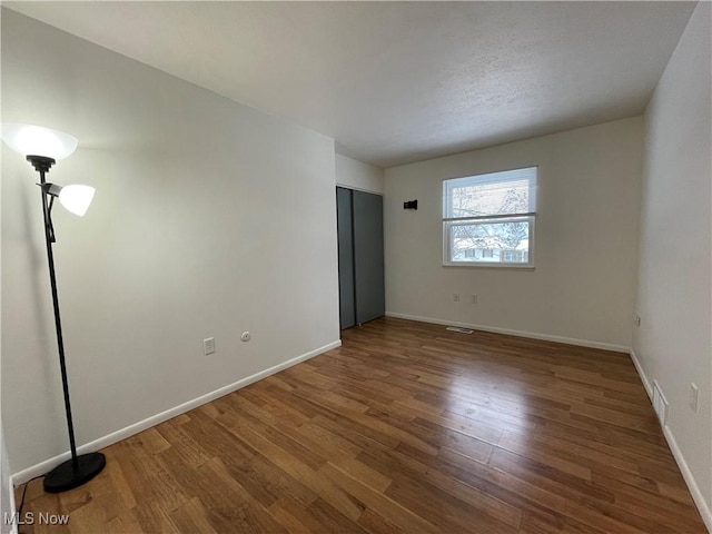 unfurnished bedroom featuring dark wood-type flooring