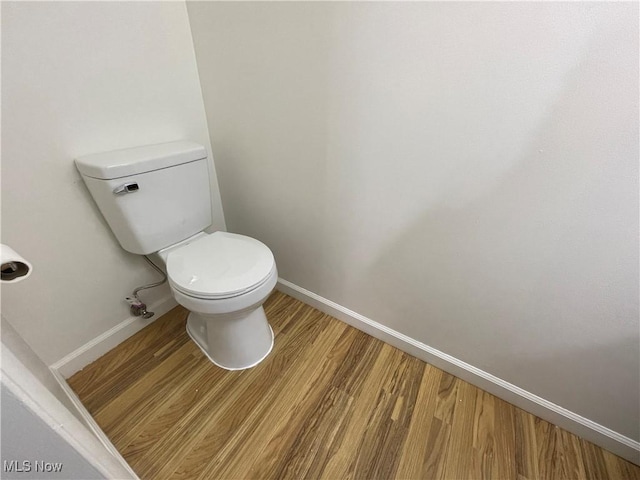 bathroom featuring hardwood / wood-style floors and toilet