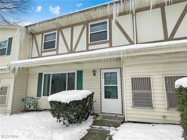 view of snow covered property entrance