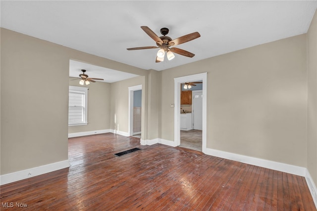 unfurnished room featuring ceiling fan and dark wood-type flooring