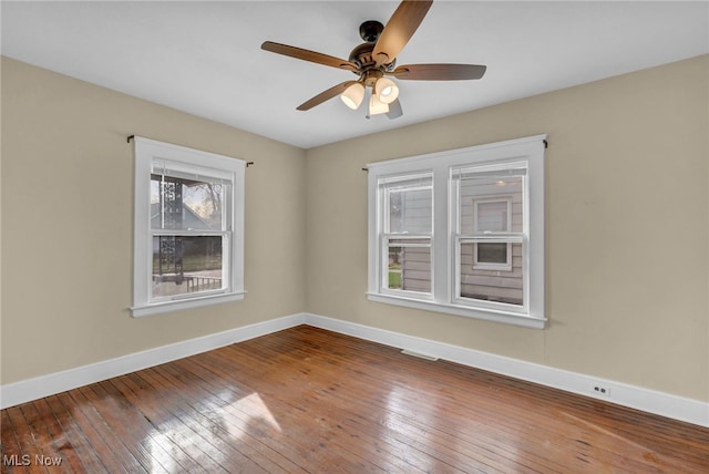 empty room with ceiling fan and wood-type flooring