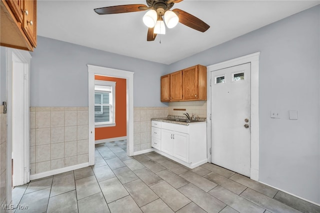 kitchen with light tile patterned floors, ceiling fan, and sink