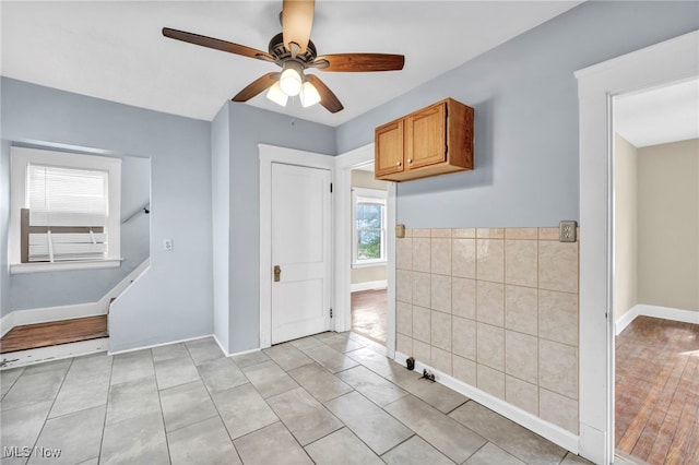 tiled empty room with ceiling fan