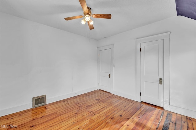 unfurnished bedroom with ceiling fan, light wood-type flooring, and lofted ceiling