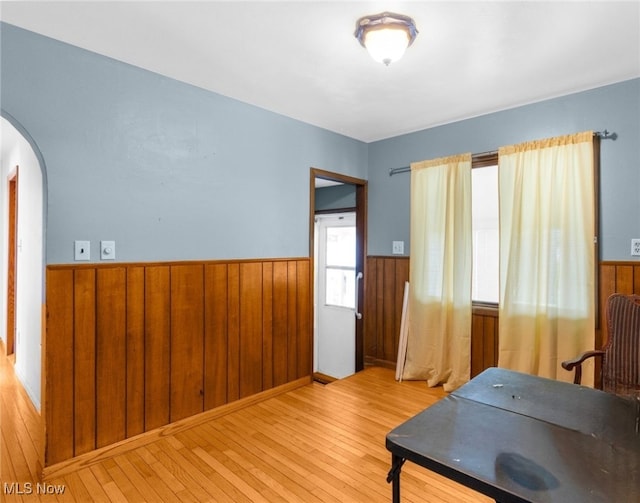 office space with light hardwood / wood-style flooring and wood walls