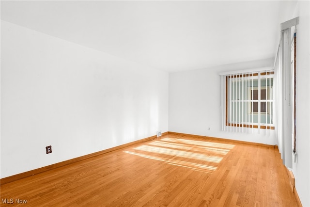 spare room with light hardwood / wood-style floors