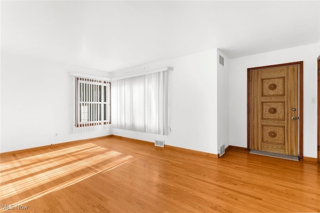 unfurnished room with hardwood / wood-style flooring