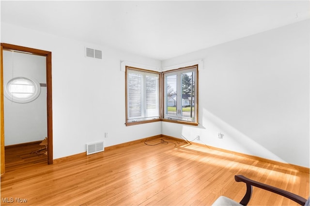 empty room with light hardwood / wood-style floors