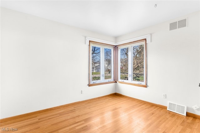 empty room with light hardwood / wood-style floors