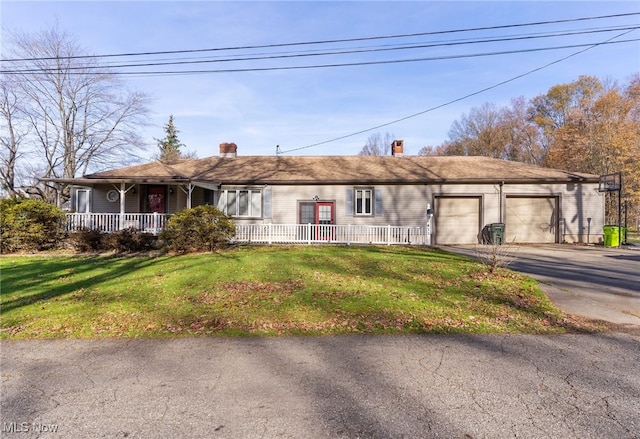 single story home with a porch, a garage, and a front lawn