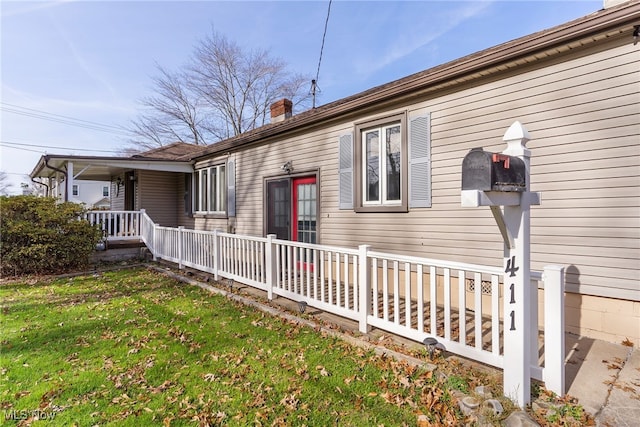 view of property exterior with a yard