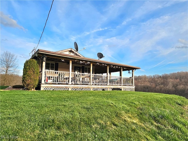 back of house with a lawn