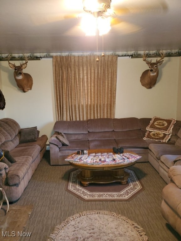 carpeted living room with ceiling fan