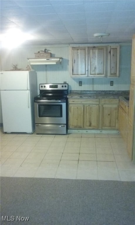 kitchen featuring white refrigerator, light tile patterned flooring, stainless steel range with electric cooktop, and exhaust hood