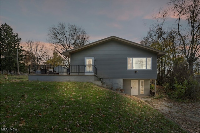 property exterior at dusk with a yard